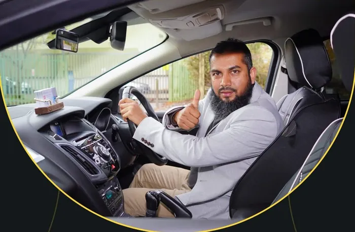 Mashud Ahmad giving a thumbs up from the driving seat